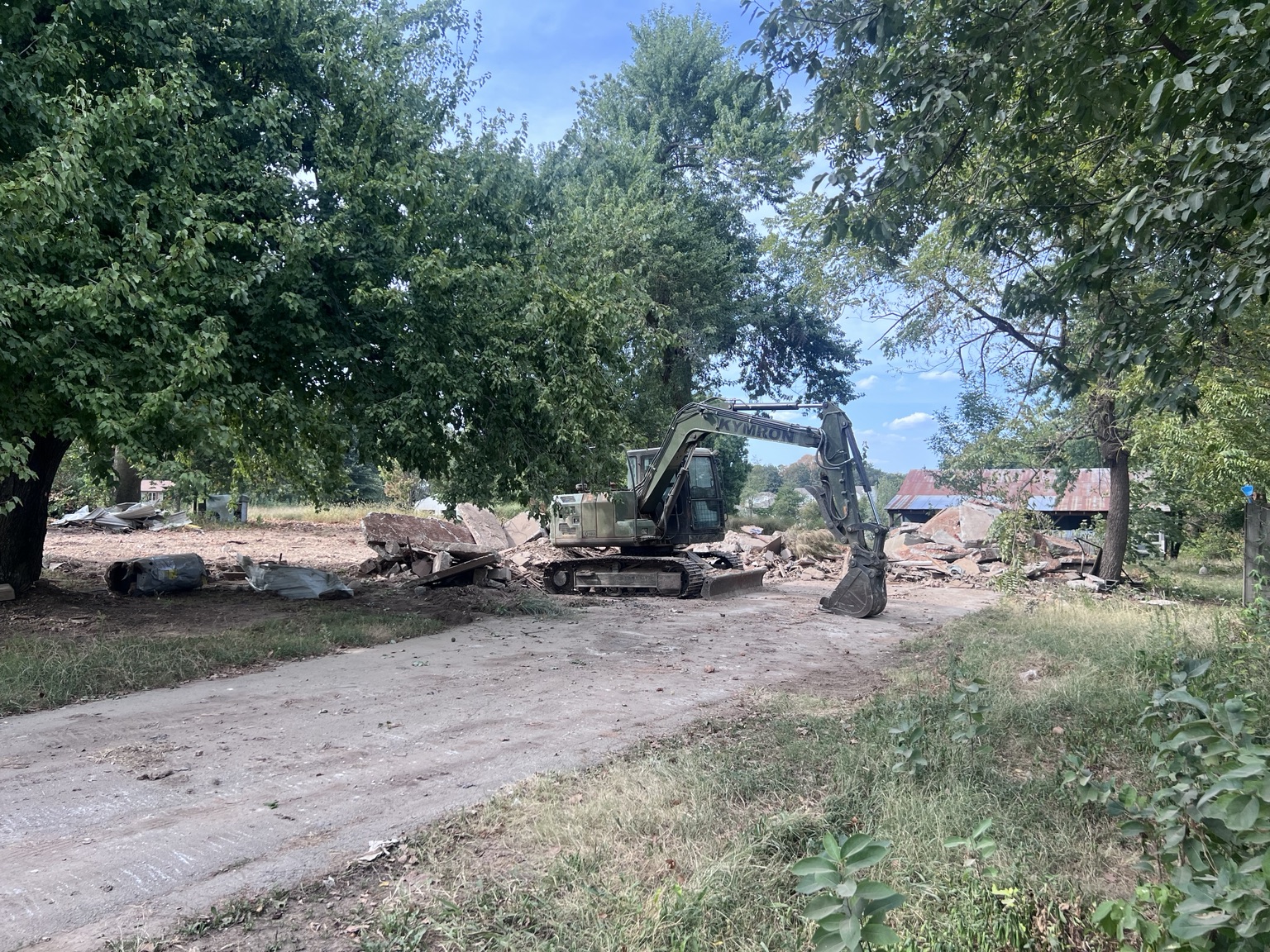 Equipment working across the access area during demolition.